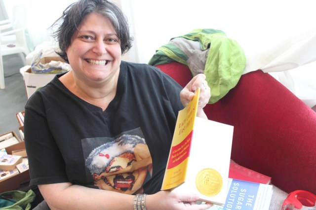 Artist Brenda Oelbaum puts Stickers in diet books that have returned from the Whitdel Gallery in Detroit 2013